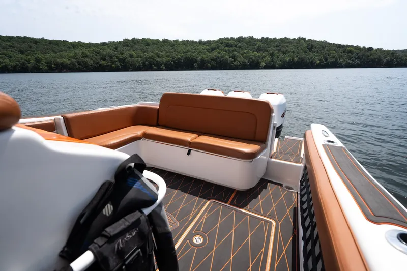 Slide: The Image of Luxury seating on a 2007 Deep Impact 360 C boat, overlooking a serene lake. - 40