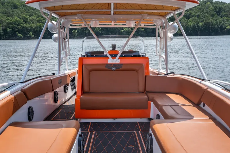 Slide: The Image of Luxurious 2007 Deep Impact 360 C boat interior with brown seating and scenic lake view. - 32
