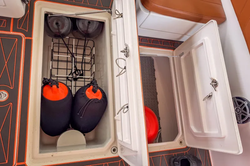 Slide: The Image of Storage compartments on a 2007 Deep Impact 360 C boat, featuring fenders and safety equipment. - 48