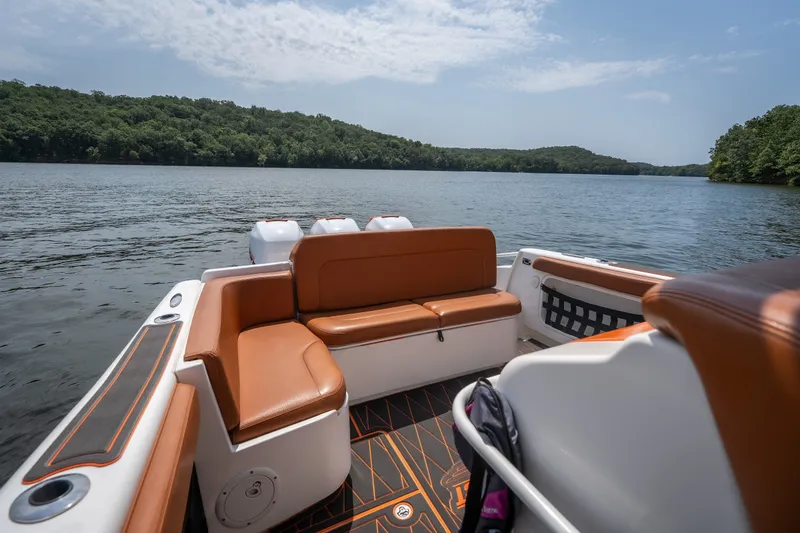 Slide: The Image of Luxury seating on a 2007 Deep Impact 360 C boat, cruising on a serene lake. - 38