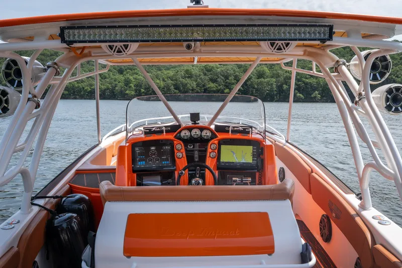 Slide: The Image of Cockpit view of 2007 Deep Impact 360 C boat with navigation equipment on a lake. - 8