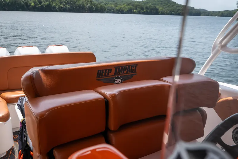 Slide: The Image of Luxury seating on a 2007 Deep Impact 360 C boat, overlooking a serene lake. - 10