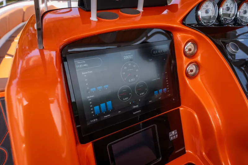 Slide: The Image of Orange dashboard of 2007 Deep Impact 360 C boat with digital display and gauges. - 15