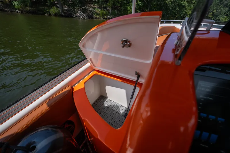 Slide: The Image of Open storage compartment on 2007 Deep Impact 360 C boat, near water. - 39