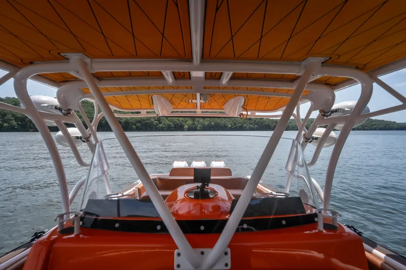 Slide: The Image of Orange canopy on 2007 Deep Impact 360 C boat, overlooking serene lake waters. - 34