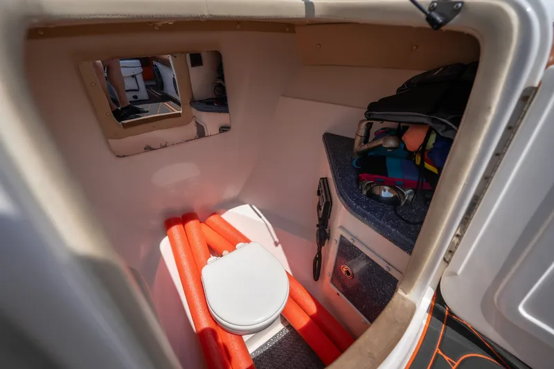 Slide: The Image of Interior of 2007 Deep Impact 360 C boat cabin with toilet and storage area. - 30
