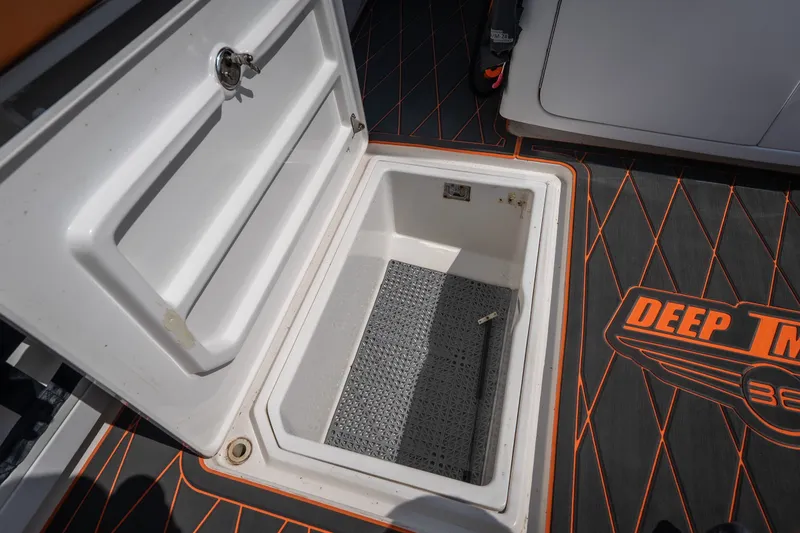 Slide: The Image of Open storage compartment on a 2007 Deep Impact 360 C boat with branded flooring. - 43
