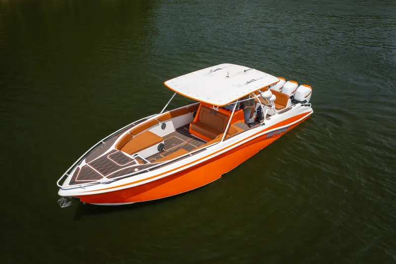 Slide: The Image of Orange 2007 Deep Impact 360 C boat on water, featuring sleek design and spacious seating. - 4