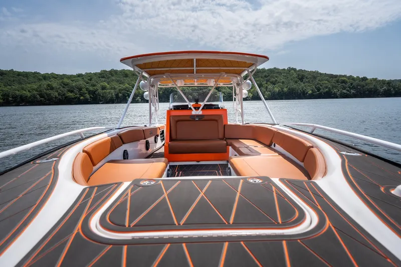 Slide: The Image of Luxury Deep Impact 360 C boat interior with orange seating, 2007 model, on a serene lake. - 31