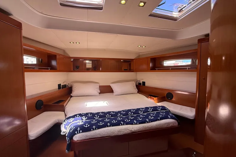 Slide: The Image of Luxurious cabin interior of 2013 Beneteau Oceanis 48 yacht with cozy bed and wooden finish. - 10