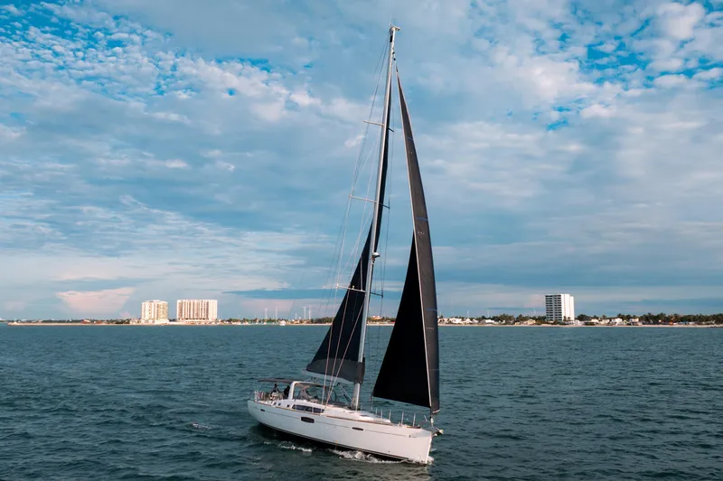 Slide: The Image of 2013 Beneteau Oceanis 48 sailing on open water under a partly cloudy sky. - 18