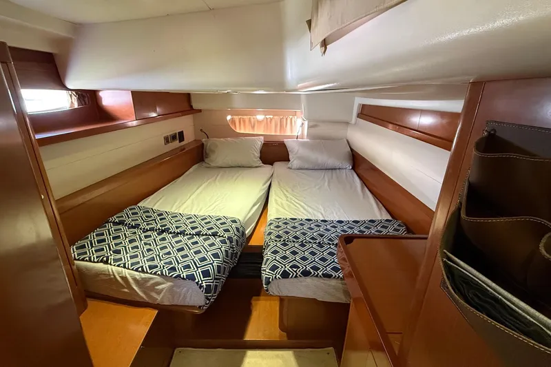 Slide: The Image of Interior cabin of 2013 Beneteau Oceanis 48 yacht with twin beds and wooden finish. - 6