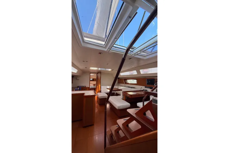 Slide: The Image of Interior of 2013 Beneteau Oceanis 48 yacht with skylights and wooden furnishings. - 5