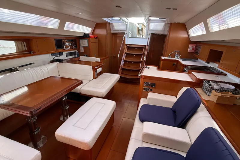 Slide: The Image of Luxurious interior of a 2013 Beneteau Oceanis 48 yacht with elegant seating and dining area. - 11