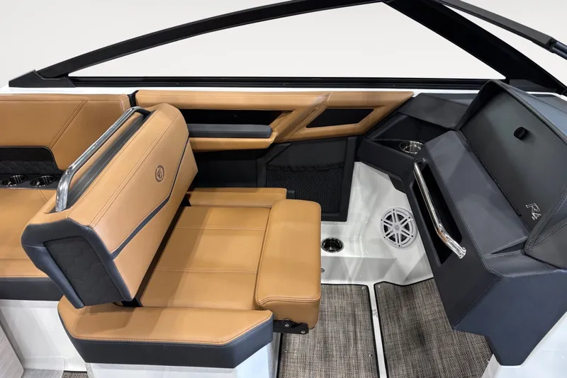 Slide: The Image of Interior of a 2026 Cobalt R4 Surf boat with brown leather seats and modern fittings. - 10