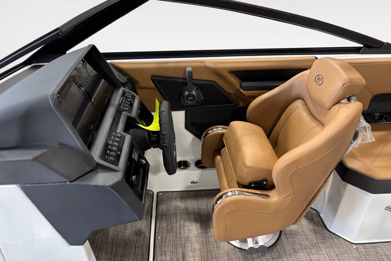 Slide: The Image of The image shows the helm of a 2026 Cobalt R4 Surf boat with a brown leather seat. - 9