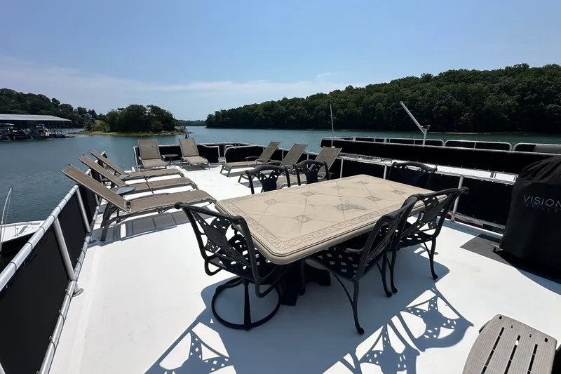Slide: The Image of Upper deck of 2006 Starlite 16x84 houseboat with lounge chairs and dining table. - 19