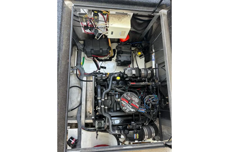 Slide: The Image of Engine compartment of a 2006 Starlite 16x84 boat, showcasing mechanical components and wiring. - 15