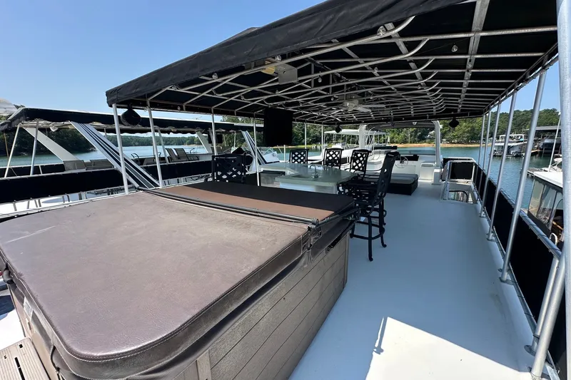 Slide: The Image of Spacious deck of 2006 Starlite 16x84 houseboat with seating and hot tub. - 18