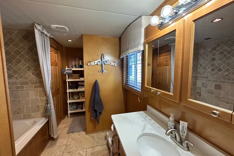 Slide: The Image of Luxurious bathroom in 2006 Starlite 16x84 houseboat with elegant wood cabinetry and tiled walls. - 13