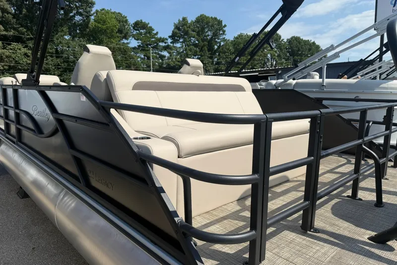 Slide: The Image of 2026 Bentley Pontoons Legacy 223 Swingback with beige seating and sleek black railing. - 8