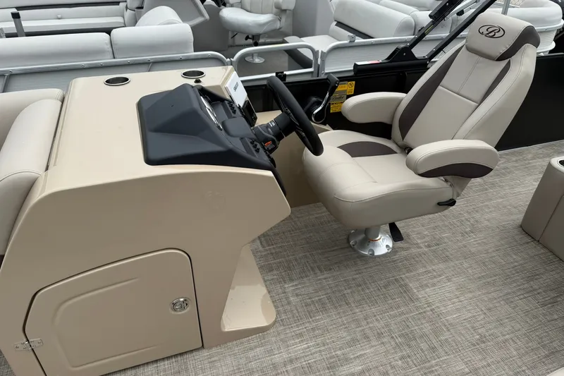 Slide: The Image of 2026 Bentley Pontoons Legacy 223 Swingback helm with beige captain's chair and dashboard. - 4