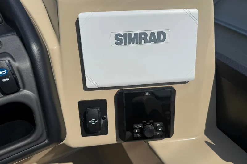 Slide: The Image of 2026 Bentley Pontoons Legacy 223 Swingback dashboard with Simrad and JBL controls. - 6