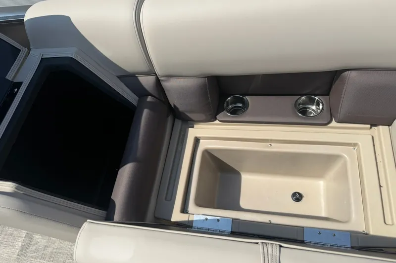 Slide: The Image of 2026 Bentley Pontoons Legacy 223 Swingback interior with cup holders and storage compartment. - 18
