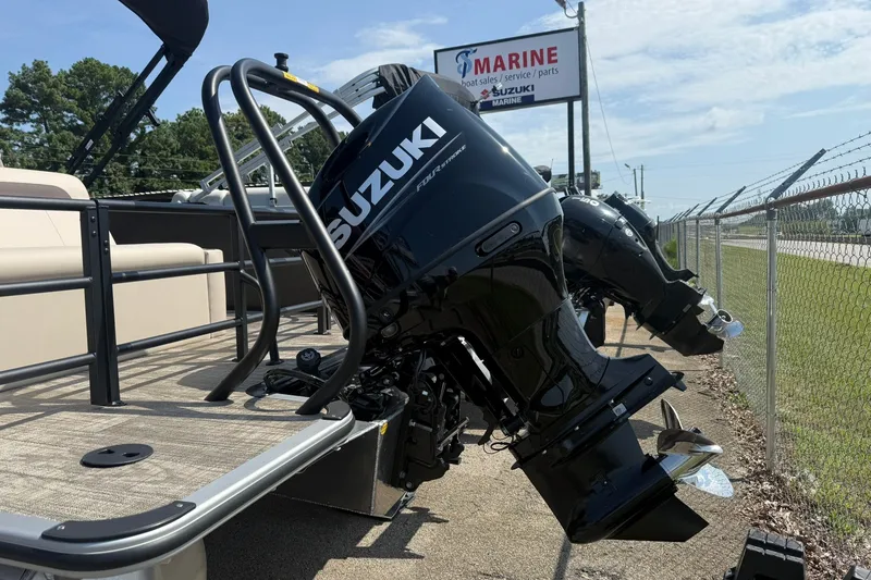 Slide: The Image of 2026 Bentley Pontoons Legacy 223 Swingback with Suzuki outboard motor at marine dealership. - 9