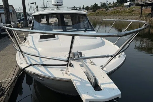 Slide: The Image of 2025 Cutwater C-248 Coupe boat docked, featuring sleek design and modern navigation equipment. - 20