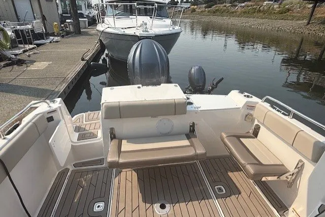 Slide: The Image of 2025 Cutwater C-248 Coupe boat with spacious deck and seating at a marina. - 17