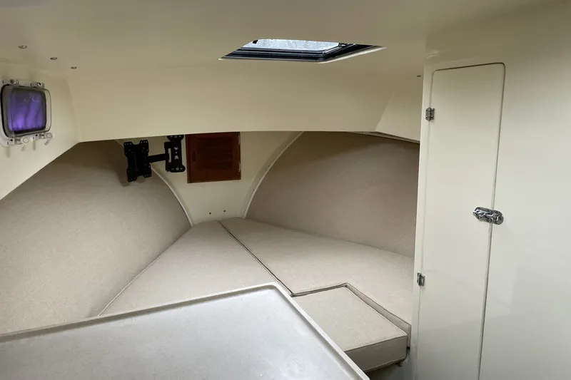 Slide: The Image of Interior cabin of 1997 General Marine 26 Downeast Cruiser with beige upholstery. - 2