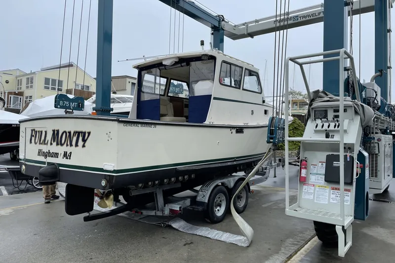 Slide: The Image of 1997 General Marine 26 Downeast Cruiser on trailer at marina, labeled "Full Monty." - 1