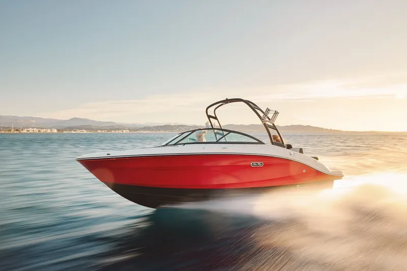 The Image of 2027 Sea Ray SPX 210 boat cruising on open water at sunset. - 1