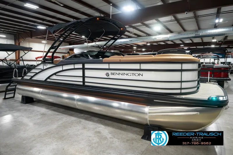 Slide: The Image of 2027 Bennington 23 RSWBA pontoon boat in showroom with sleek design and modern features. - 5