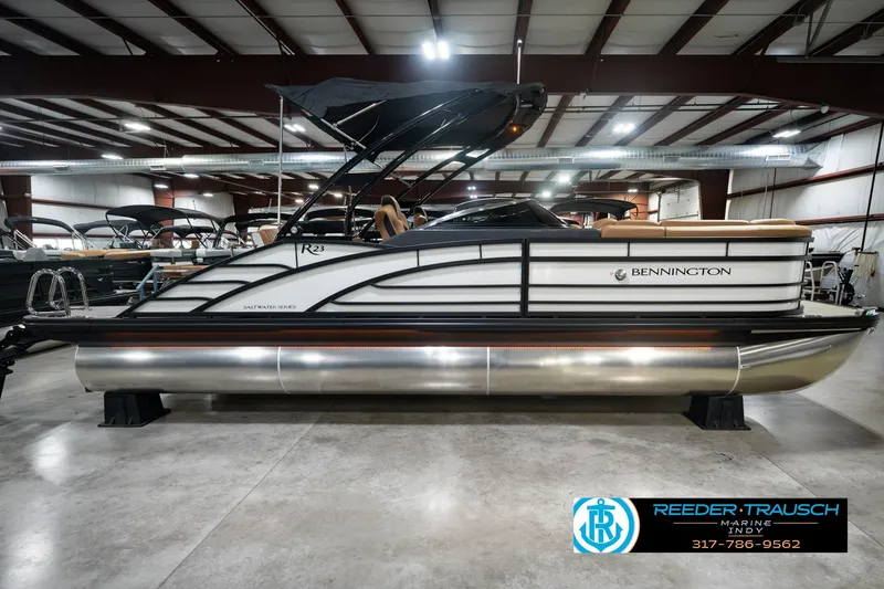 Slide: The Image of 2027 Bennington 23 RSWBA pontoon boat displayed in a showroom. - 6