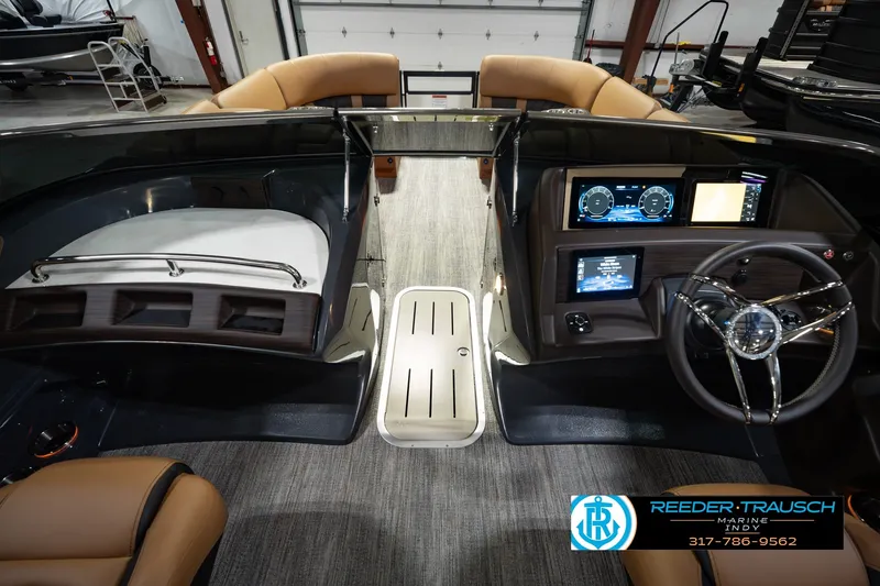 Slide: The Image of 2027 Bennington 23 RSWBA boat interior with modern dashboard and steering wheel. - 24