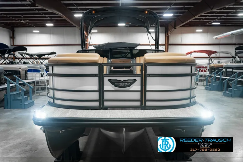 Slide: The Image of 2027 Bennington 23 RSWBA pontoon boat displayed in a showroom with ambient lighting. - 4