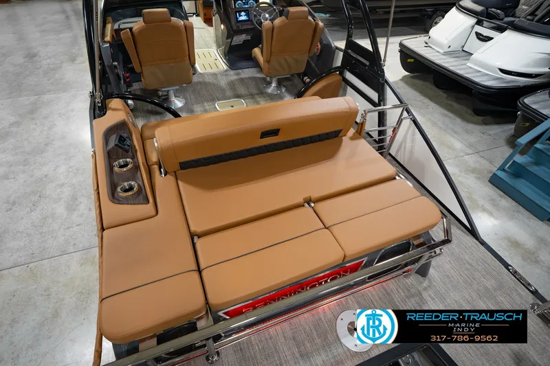 Slide: The Image of 2027 Bennington 23 RSWBA boat interior with tan seating and modern dashboard. - 17