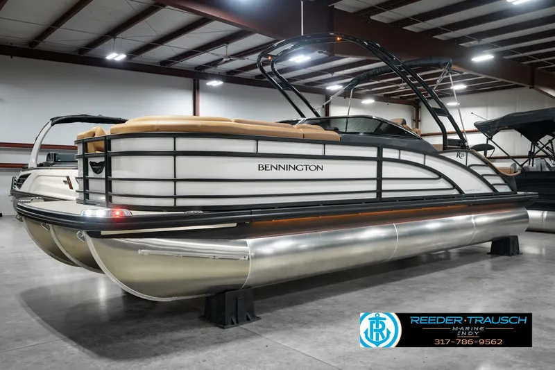 Slide: The Image of 2027 Bennington 23 RSWBA pontoon boat in showroom, featuring sleek design and modern amenities. - 1
