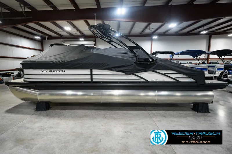 Slide: The Image of 2027 Bennington 23 RSWBA pontoon boat with cover in indoor showroom. - 59