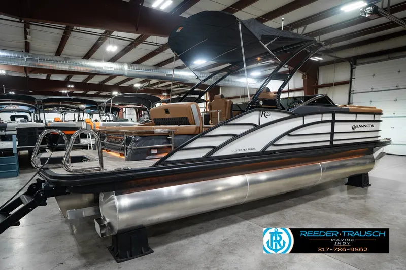Slide: The Image of 2027 Bennington 23 RSWBA pontoon boat displayed indoors at Reeder-Trausch Marine. - 8