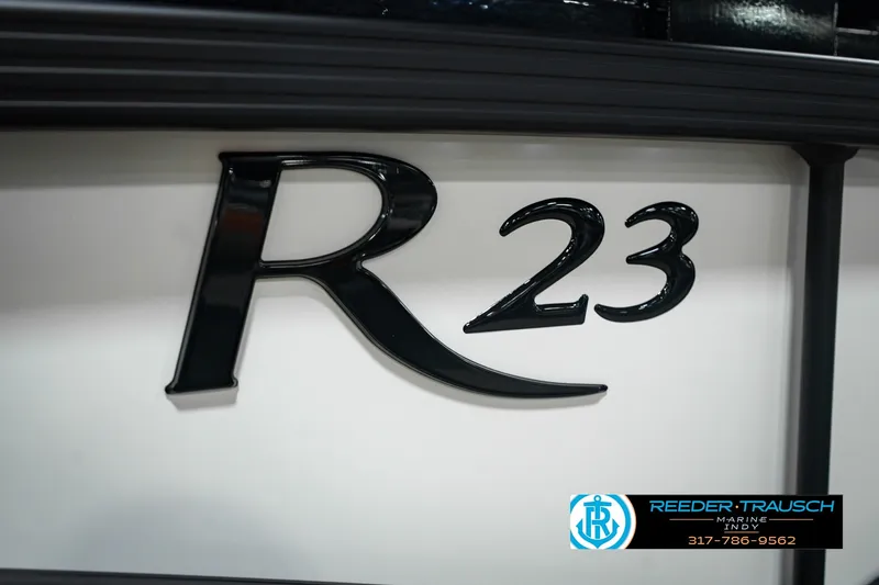 Slide: The Image of 2027 Bennington 23 RSWBA boat emblem with Reeder-Trausch Marine logo. - 56