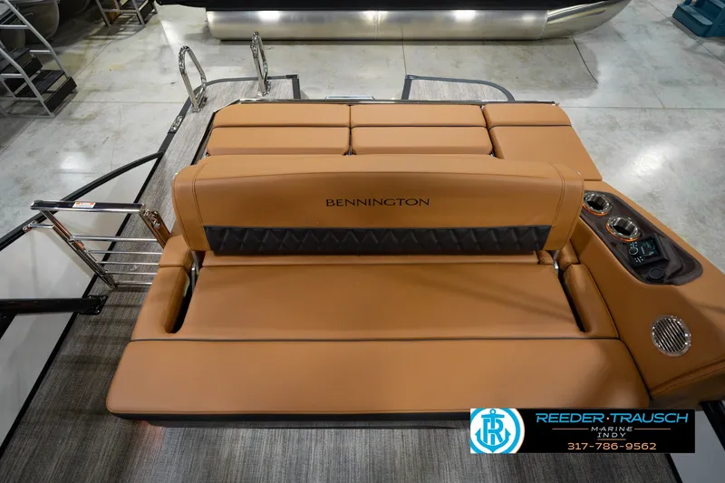 Slide: The Image of 2027 Bennington 23 RSWBA boat interior with tan seating and control panel. - 21
