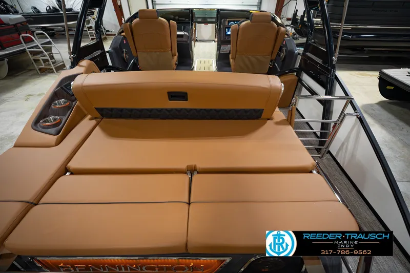 Slide: The Image of 2027 Bennington 23 RSWBA boat interior with tan seating and modern dashboard. - 22