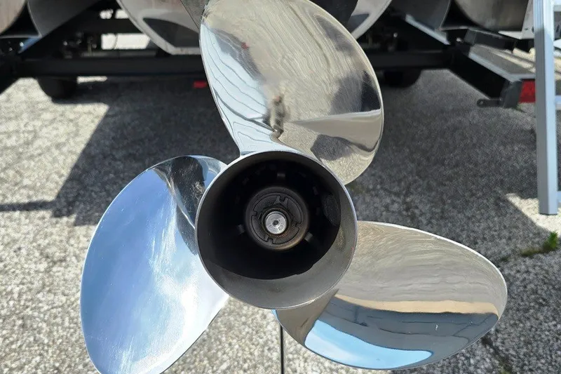 Slide: The Image of 2024 Godfrey Sweetwater 2286 SBC boat propeller, shiny metal blades, close-up view. - 8