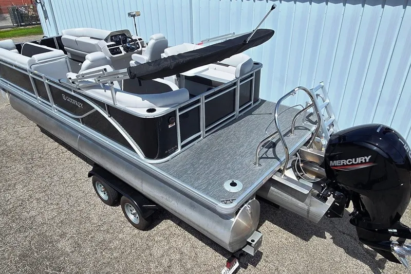 Slide: The Image of 2024 Godfrey Sweetwater 2286 SBC pontoon boat with Mercury engine, parked on trailer. - 1