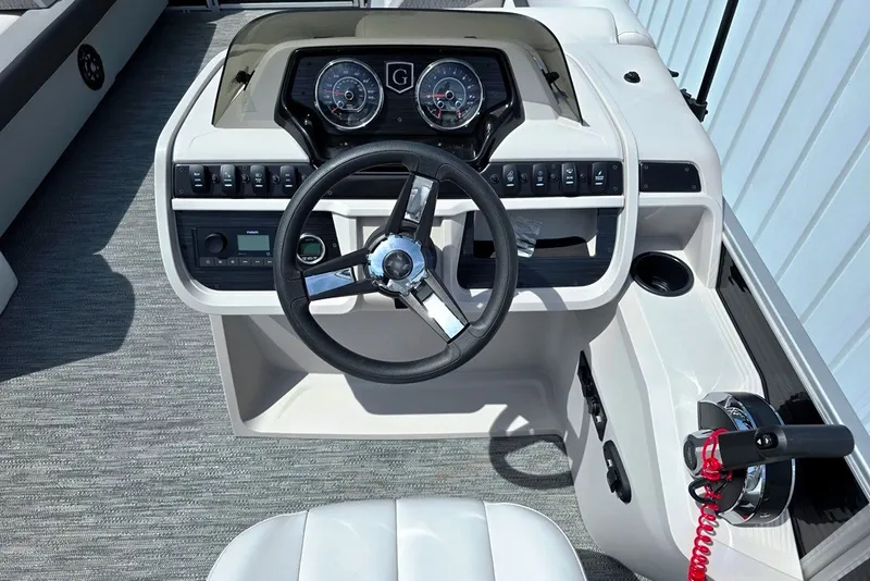 Slide: The Image of 2024 Godfrey Sweetwater 2286 SBC boat dashboard with steering wheel and control panel. - 10