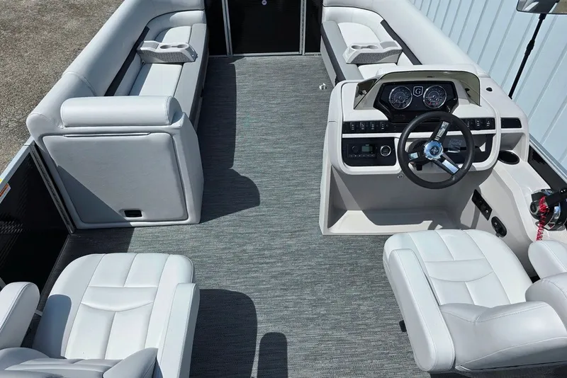 Slide: The Image of 2024 Godfrey Sweetwater 2286 SBC boat interior with plush seating and modern helm controls. - 5