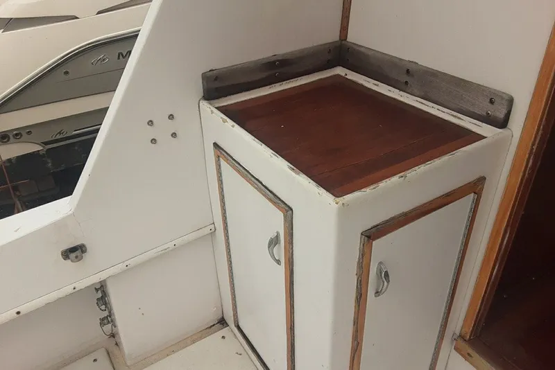 Slide: The Image of 1968 Hatteras 38 Convertible boat interior with wooden cabinet and white trim. - 9